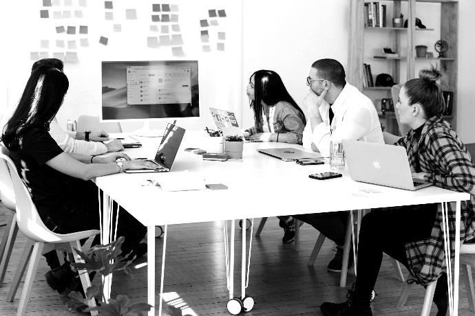 five person by table watching turned on white iMac
